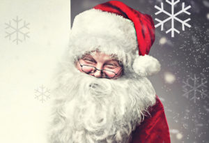 Smiling Santa Claus pointing on blank advertisement banner backg